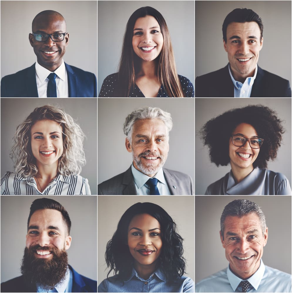 A diverse group of smiling professionals. Contact virtual mediation today to discuss and schedule confidential mediation services with Dr. Ben Earwicker, Ph.D.
